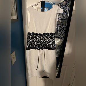 White with black detail sheath dress. Reminds me of Olivia Pope in Scandal